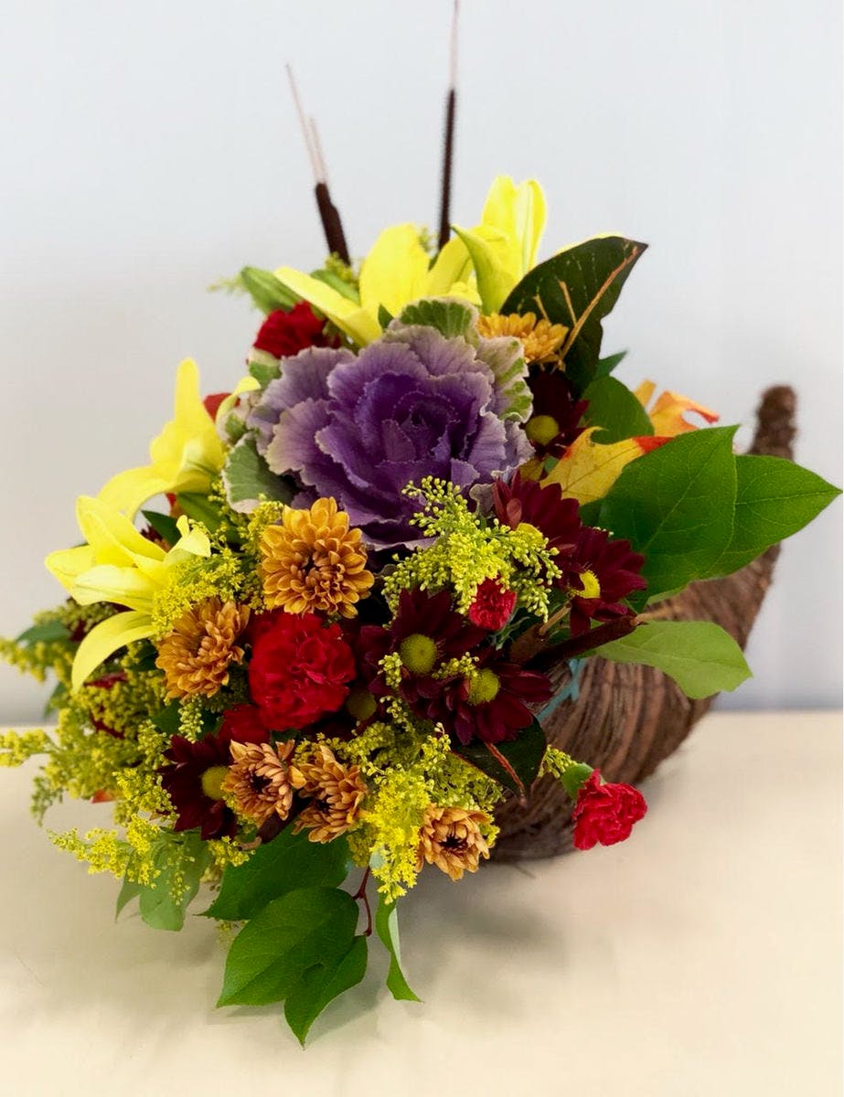 Cornucopia filled with fall flowers.