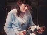 An early-century portrait of Mrs. Boswell, arranging flowers in the shop